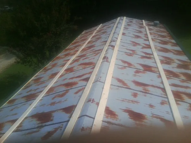 Rusted metal roof panels with new wood purlins before replacement — Storm Damage Roof Repair in Little Rock by Roofing Brothers